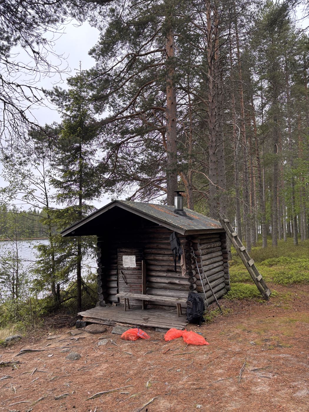 Rustic log sauna on a lakeshore